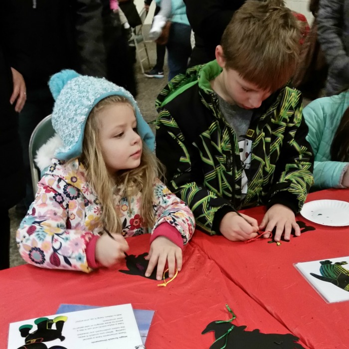 Lansing Kids Holiday Event Crafts Santa Girl and Boy making a craft Lansing Mid Michigan