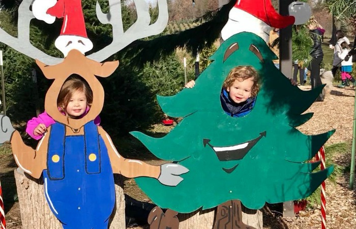 Two-young-kids-in-reindeer-and-christmas-tree-picture-boards Tree Farm Lansing Two-young-kids-in-reindeer-and-christmas-tree-picture-boards Tree Farm Lansing