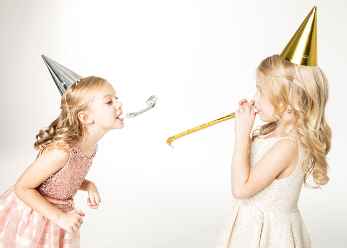 New-Years-Eve-in-Lansing-with-Family Girls in silver and gold party hats