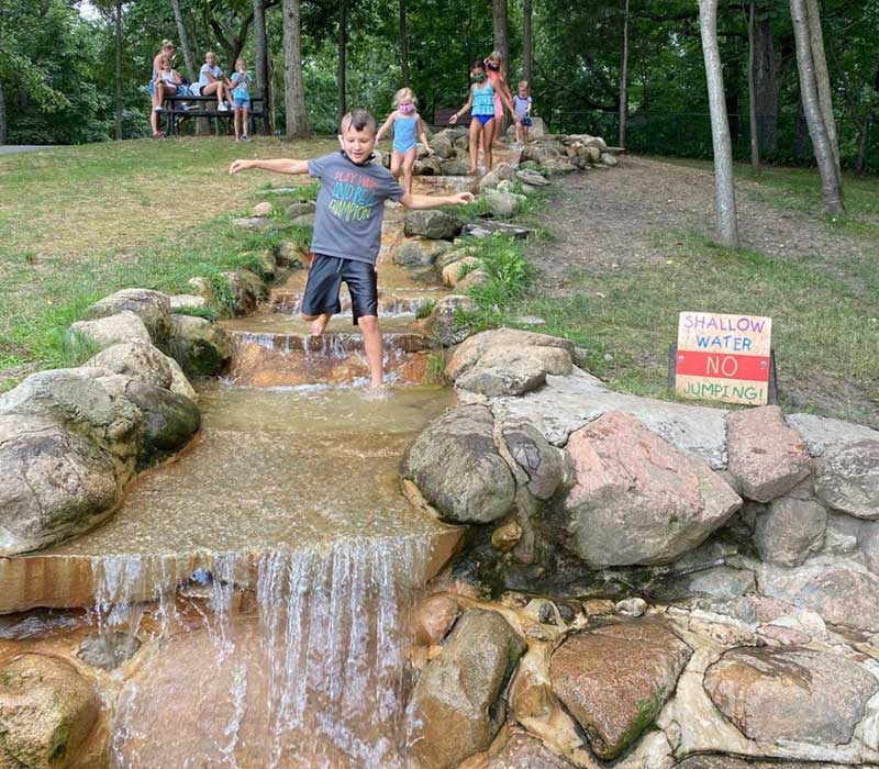Howell-Nature-Center-kids-playing-in-the-water-creek