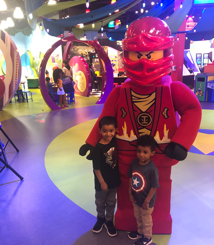 posing with a giant minifigure at legoland detroit