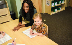 AppleTree-Gilden-Woods-teacher-with-kids-learning-writing