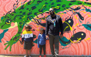 Mural-street-art-kids-with-dad-by-the-Adado-Riverfront-mural