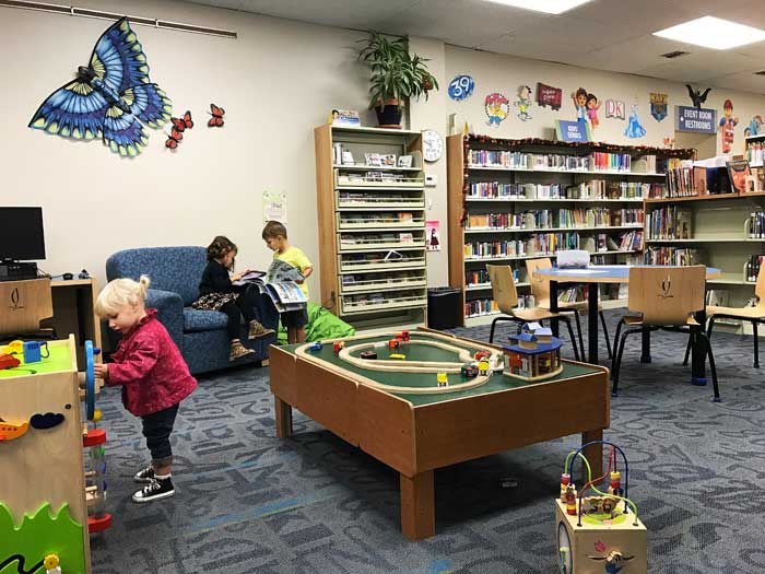 Okemos_Library_Children_Area-kids-picking-out-books