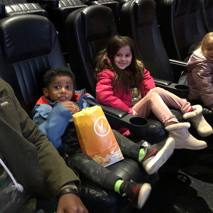 Movie-Theatre-kids-eating-popcorn-and-waiting-for-movie-to-start