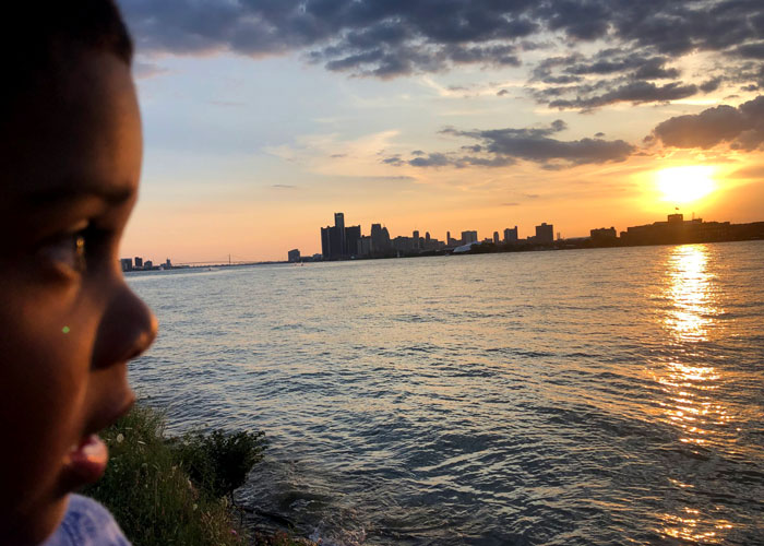 Belle-Isle-Sunset-Point-Kid-gazing-on-detroit-riverfront