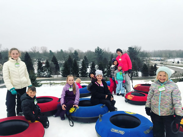 Hawk-Island-Tubing-Hill-group-smiling-with-tubes