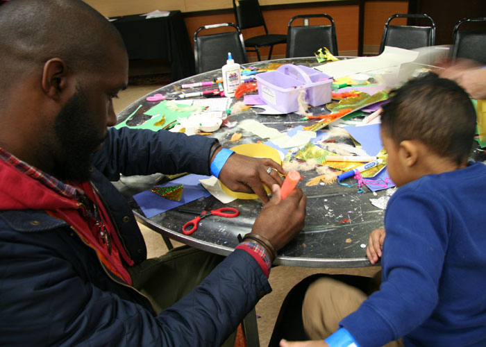 MLK-Day-Black-History-Month-Celebration-dad-and-son-creating-a-craft-together