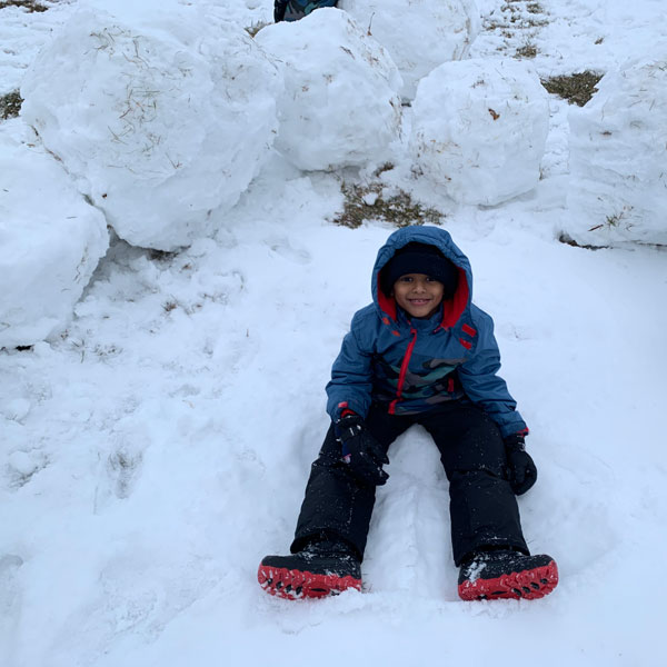 Michigan Winter Fun boy with giant snowballs