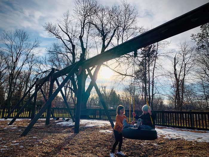 Winter-Blues-and-SAD-hacks-kids-playing-on-tire-swing-at-rayner-park