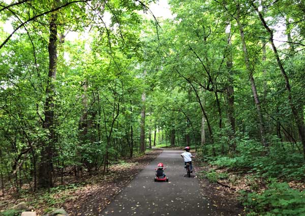 summer things to do - kids-riding-bikes-through-trail