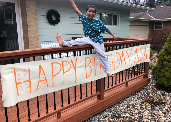 Birthday-Parties-during-Covid-19-Boy-with-sign-up-on-porch