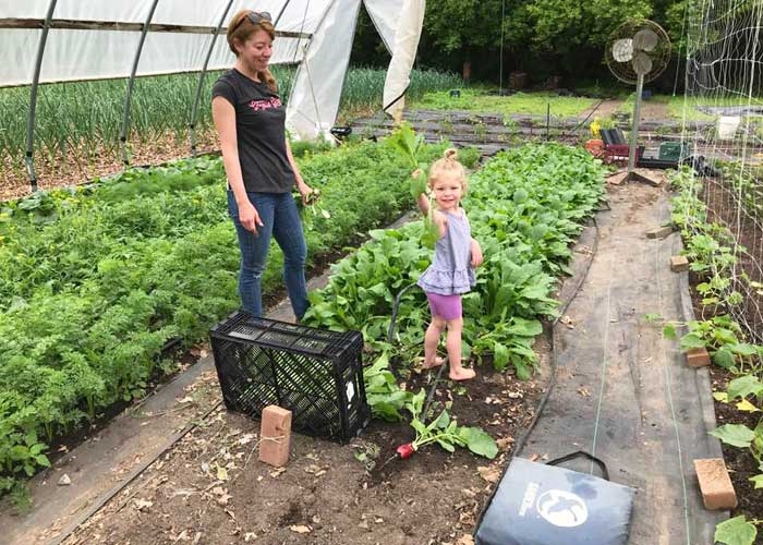 CSAs-kid in the garden with mom feature-image