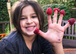 Gardening-with-Kids,-Girl-with-raspberry-fingers